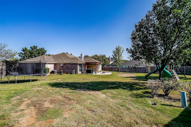 view of yard with a patio, a playground, a trampoline, and central air condition unit