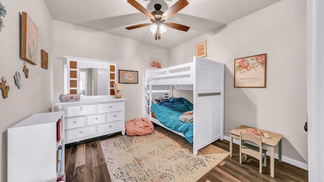 bedroom with ceiling fan and dark wood-type flooring