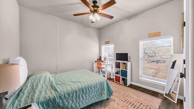 bedroom featuring ceiling fan and dark wood-type flooring