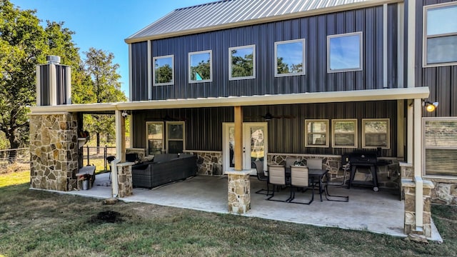 back of house featuring a patio area and an outdoor living space