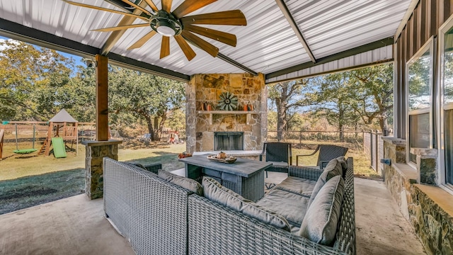 view of patio / terrace featuring a playground and an outdoor living space with a fireplace