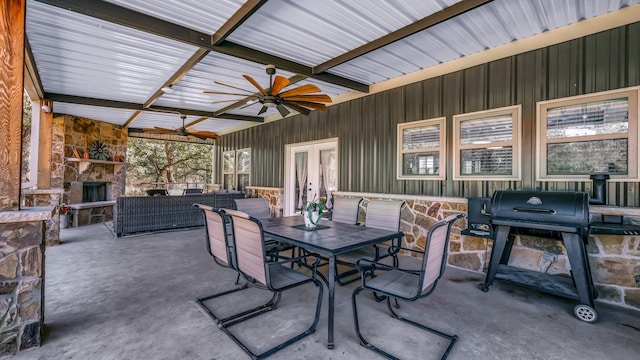 view of patio featuring ceiling fan, area for grilling, french doors, and an outdoor living space with a fireplace