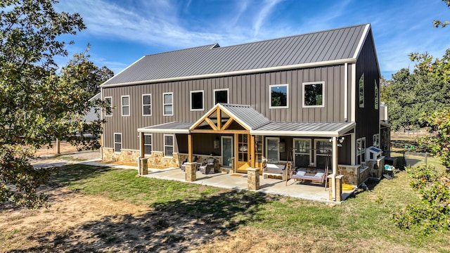 back of house featuring a yard and a patio