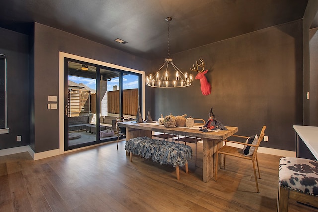 dining room with a notable chandelier and wood-type flooring