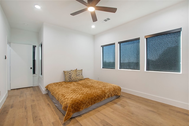 bedroom featuring hardwood / wood-style floors and ceiling fan