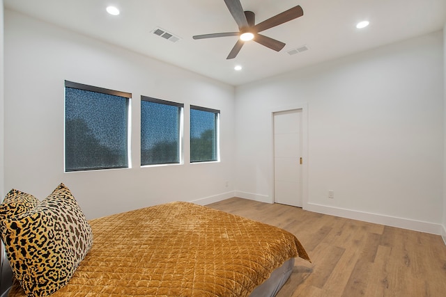 bedroom with light wood-type flooring and ceiling fan