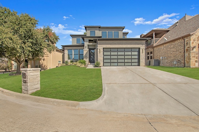 modern home with central AC, a front yard, and a garage