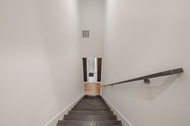 staircase with hardwood / wood-style floors