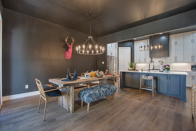 dining room featuring sink and dark hardwood / wood-style flooring