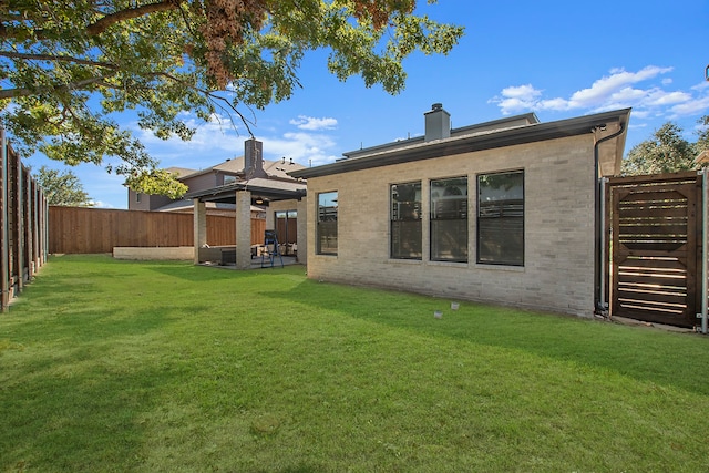 rear view of property with a lawn