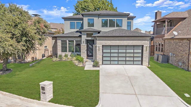 view of front facade featuring a front yard, central AC, and a garage