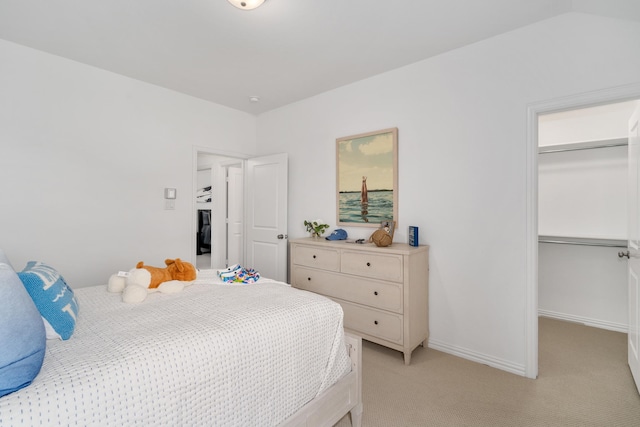 carpeted bedroom featuring a closet and vaulted ceiling