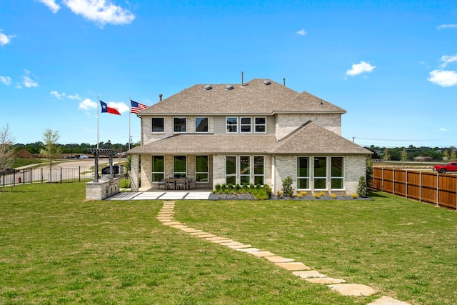 back of property featuring a patio and a lawn