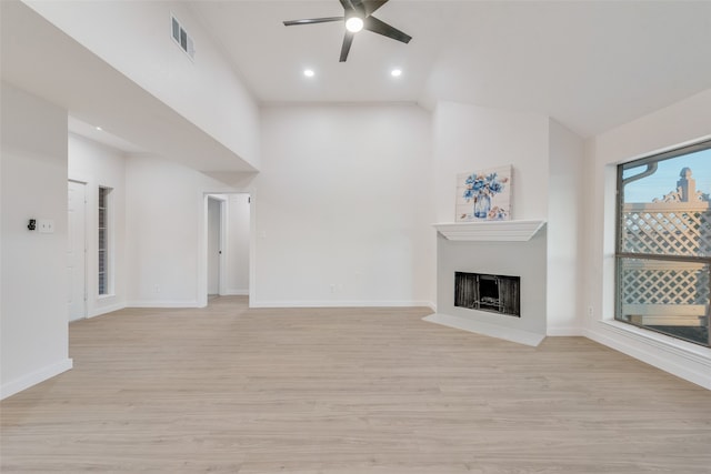 unfurnished living room with light hardwood / wood-style floors, lofted ceiling, and ceiling fan