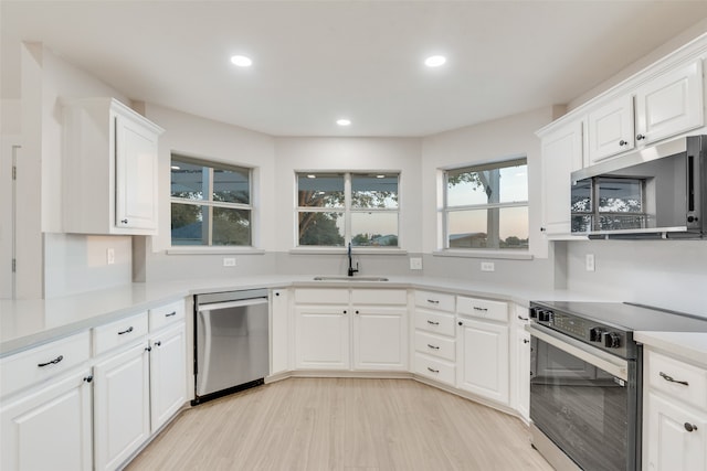 kitchen with white cabinets, stainless steel appliances, and sink