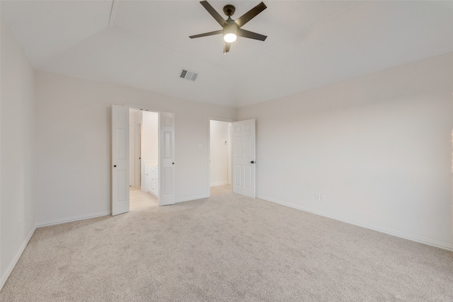 carpeted empty room featuring lofted ceiling and ceiling fan