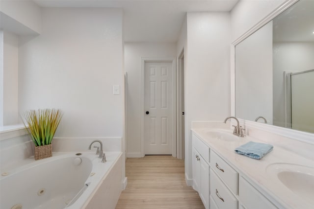 bathroom with vanity, hardwood / wood-style floors, and shower with separate bathtub