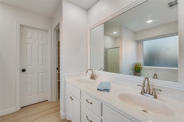 bathroom with vanity, hardwood / wood-style flooring, and walk in shower