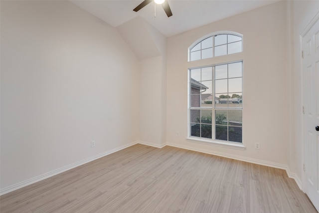 unfurnished room featuring vaulted ceiling, light wood-type flooring, and ceiling fan