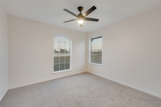 spare room with carpet and ceiling fan