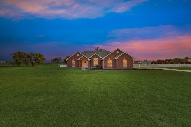 single story home with a lawn