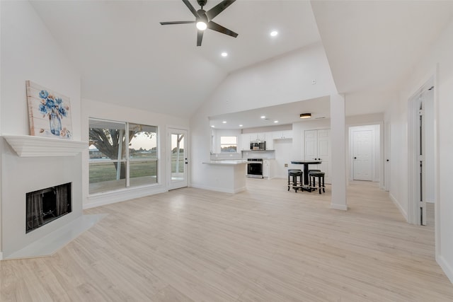 unfurnished living room featuring ceiling fan, high vaulted ceiling, and light hardwood / wood-style flooring