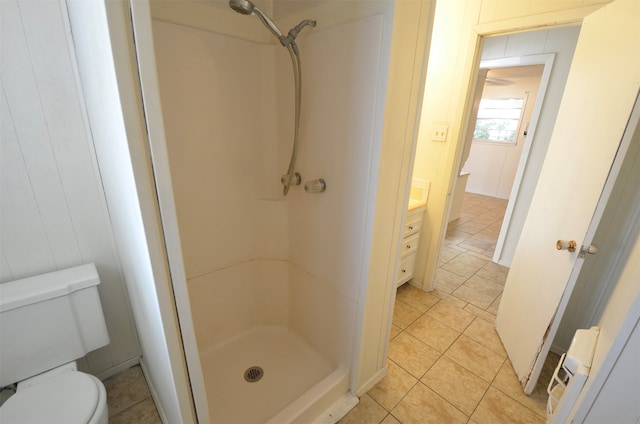 bathroom with vanity, toilet, tile patterned floors, and walk in shower