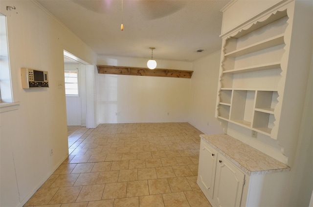 unfurnished room with light tile patterned floors