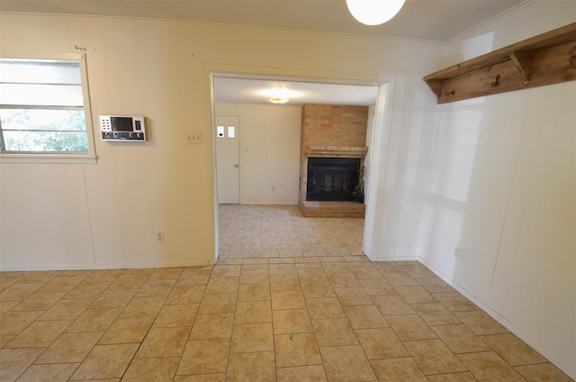 empty room featuring ornamental molding and a fireplace