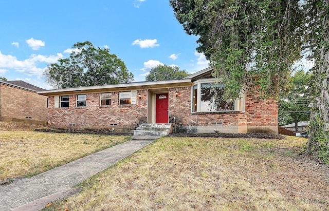 ranch-style home featuring a yard