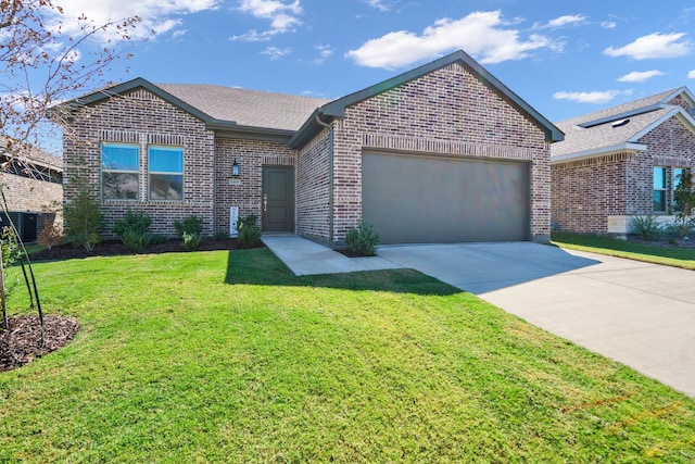 view of front of property featuring a front yard and a garage