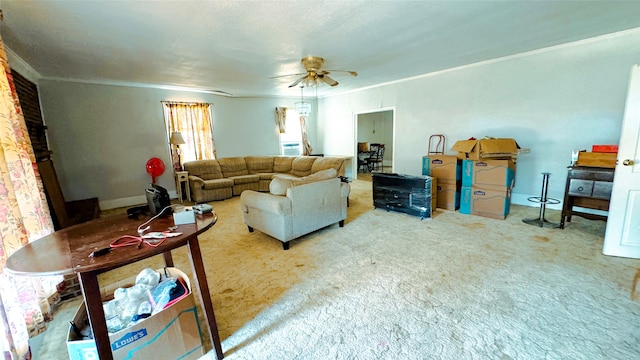 living room featuring ornamental molding, carpet flooring, and ceiling fan