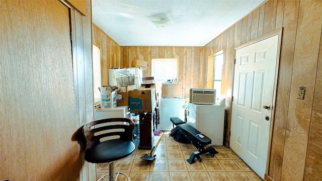 workout room with washer / dryer and wood walls