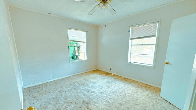 empty room featuring light colored carpet and ceiling fan