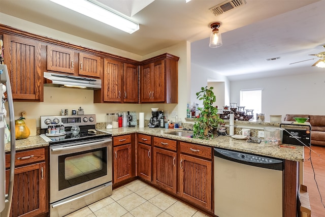 kitchen featuring stainless steel appliances, light tile patterned flooring, light stone counters, kitchen peninsula, and ceiling fan