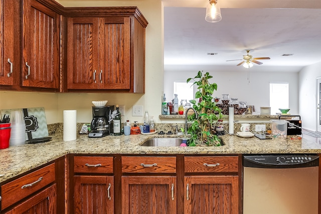 kitchen featuring dishwasher, light stone countertops, sink, and ceiling fan