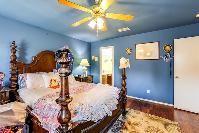 bedroom with ensuite bath, ceiling fan, and dark hardwood / wood-style flooring