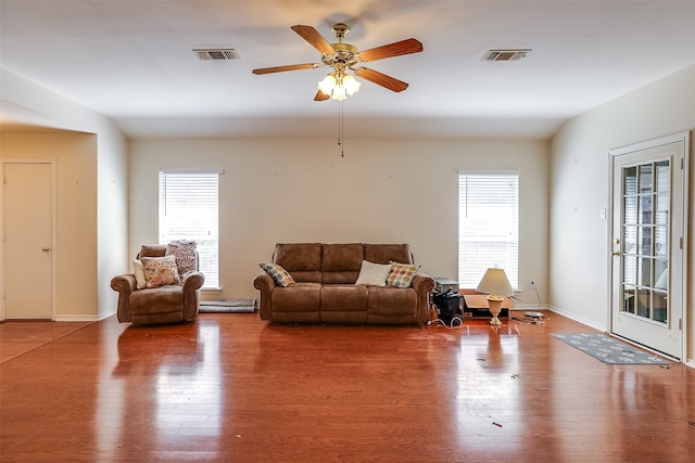 living room with wood-type flooring and ceiling fan