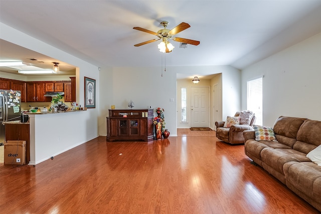 living room featuring wood-type flooring and ceiling fan