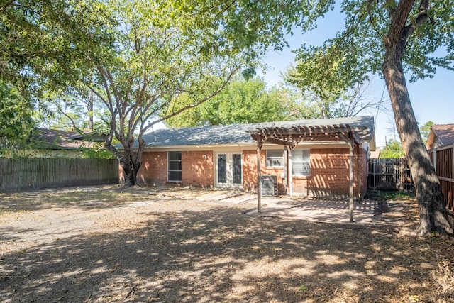 back of property featuring cooling unit and a pergola