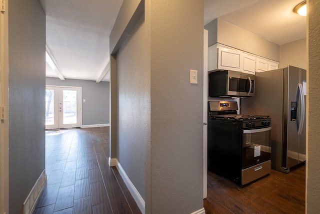 interior space featuring beamed ceiling, dark wood-type flooring, and french doors