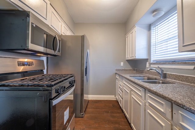 kitchen featuring sink, stainless steel appliances, dark hardwood / wood-style flooring, and white cabinets