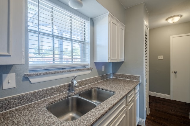 kitchen with white cabinetry, sink, and dark hardwood / wood-style floors