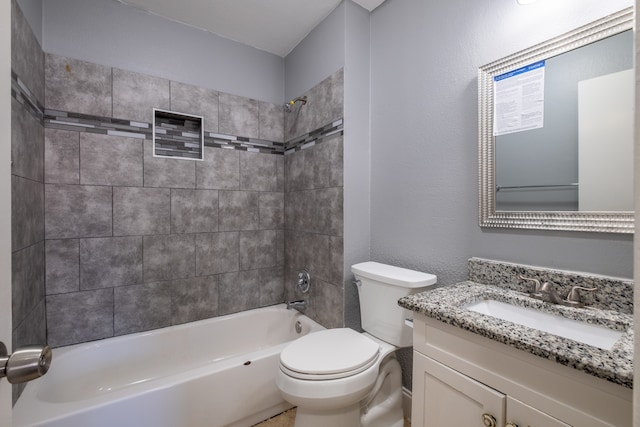 full bathroom with toilet, tiled shower / bath combo, and vanity