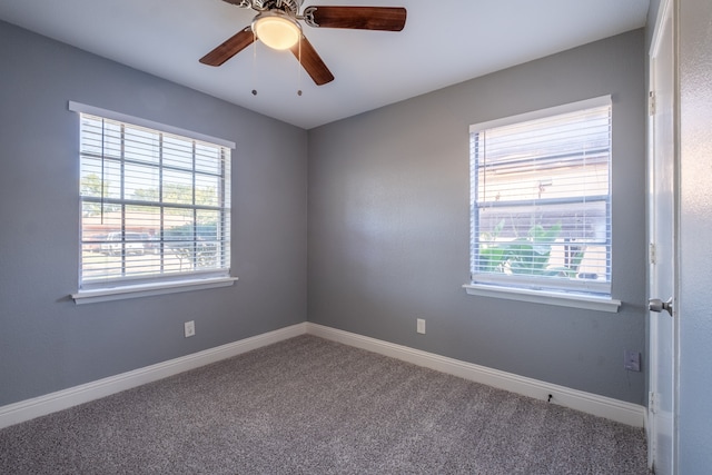 carpeted spare room with ceiling fan