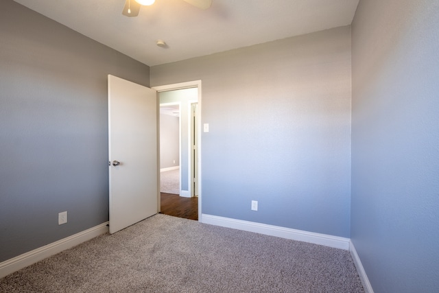 carpeted spare room with ceiling fan