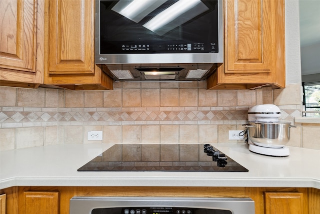 kitchen featuring stainless steel appliances and backsplash