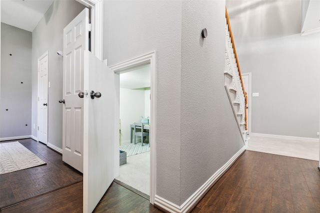 hallway with dark wood-type flooring