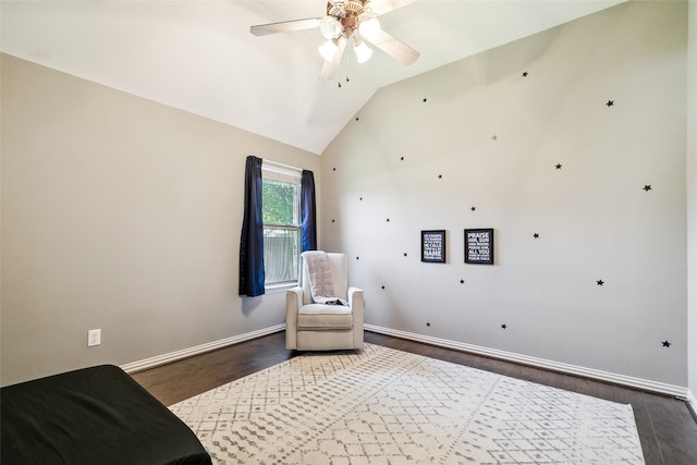 living area with lofted ceiling, dark wood-type flooring, and ceiling fan