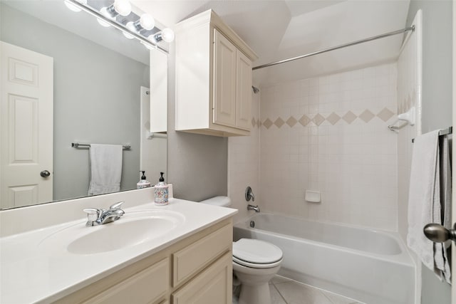 full bathroom with tiled shower / bath, vanity, toilet, and tile patterned floors